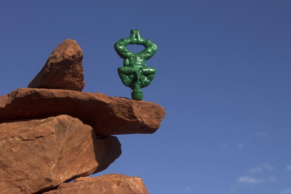 Yoga Joe doing a headstand on a rockpile.